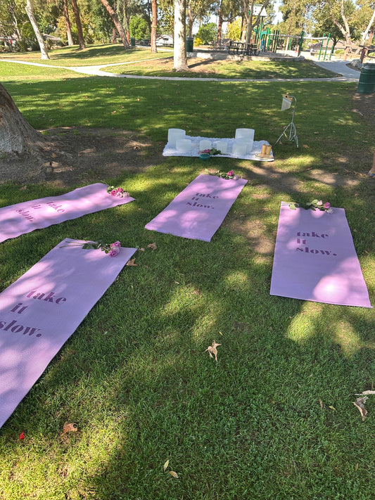 Sound bath set up in a park with purple yoga mats