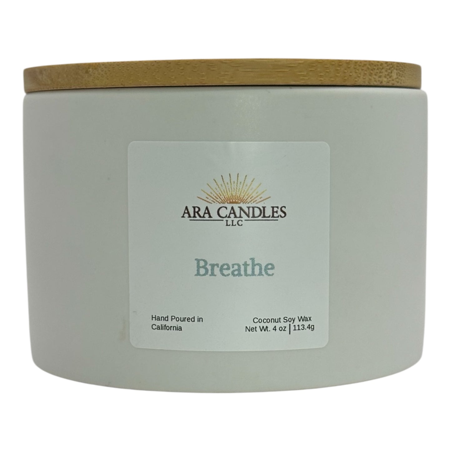 White ceramic candle labeled Breathe from Ara Candles, with wooden lid, designed for clarity and breath work rituals.