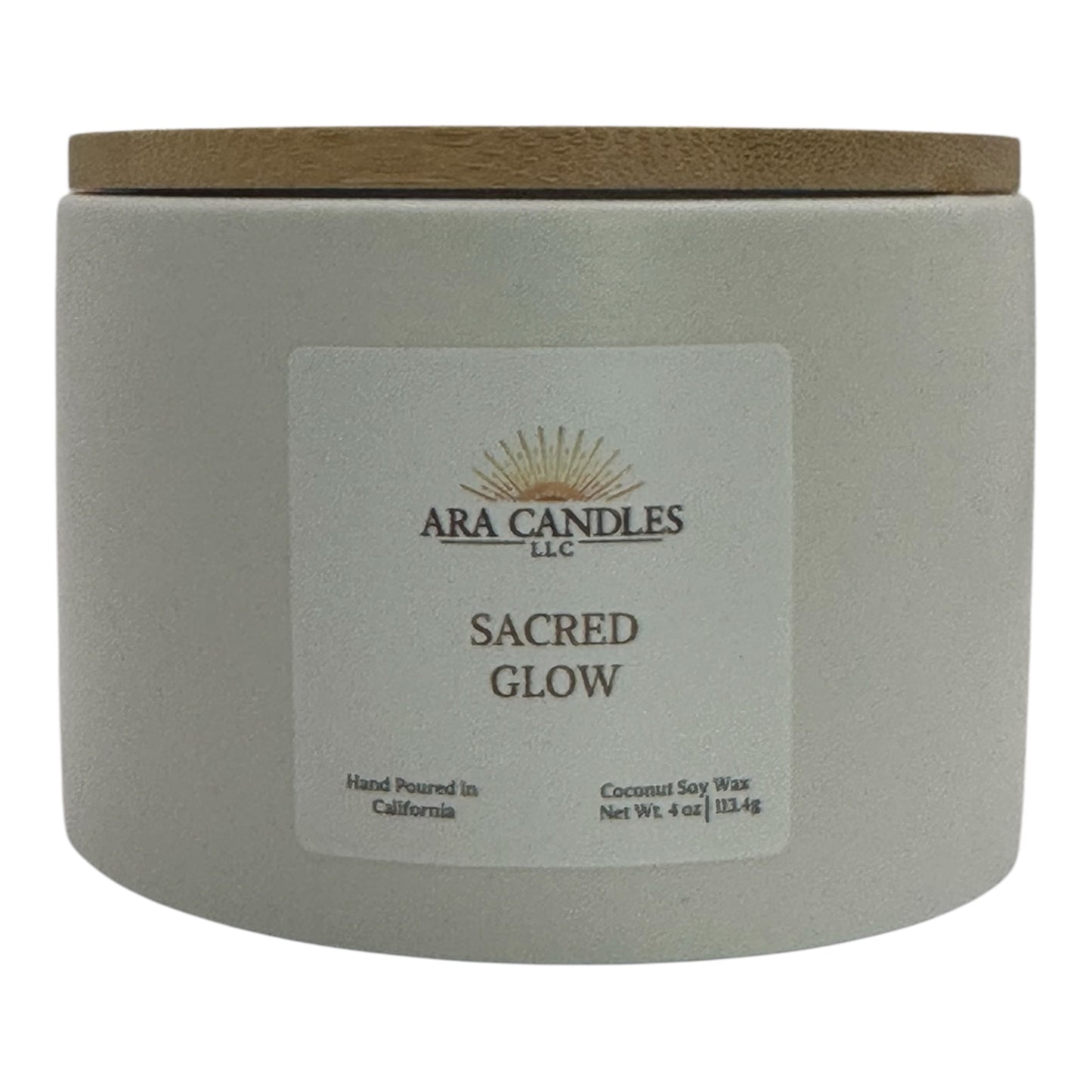 Sacred Glow candle from ARA Candles, minimalist white vessel with grounding palo santo and grapefruit scent.