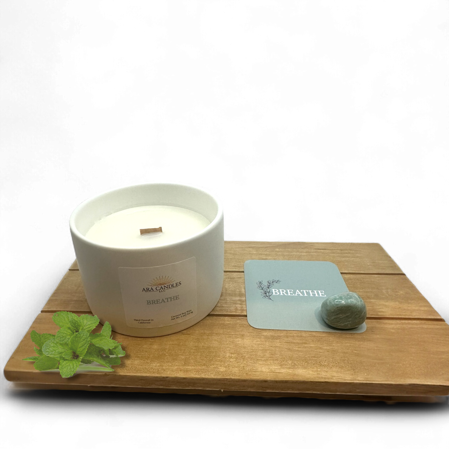 BREATHE ritual candle displayed with affirmation card, Amazonite stone, and fresh mint on wooden board.