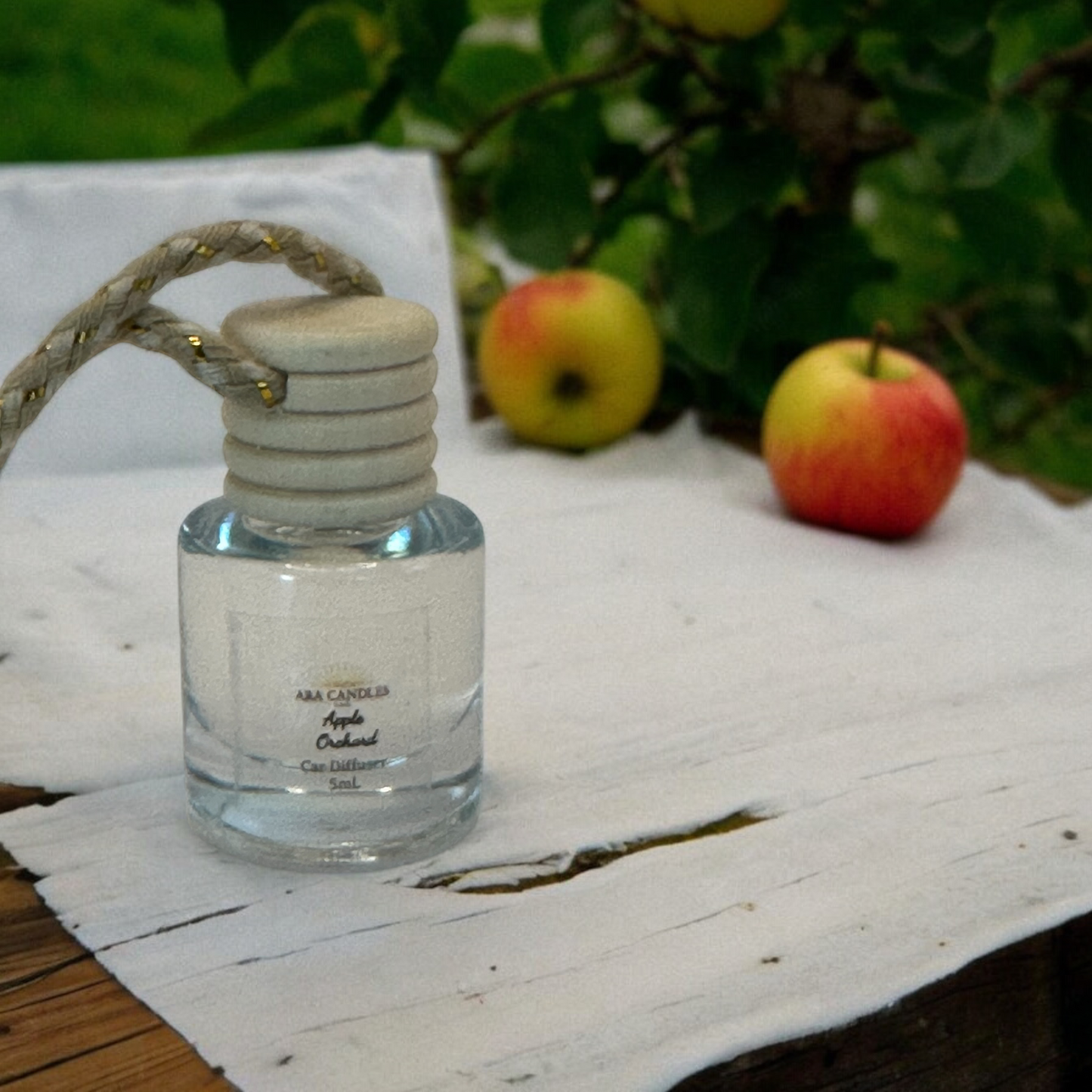 Car diffuser with background image of apples to tie the scent to the image