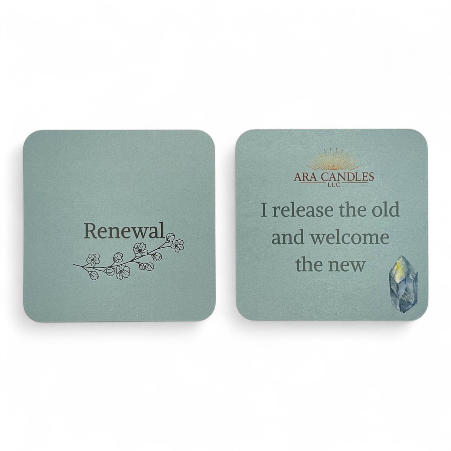 RENEWAL affirmation card set from ARA Candles, with soft sage coloring, blossoming branch artwork, and the quote "I release the old and welcome the new" beside a healing crystal.
