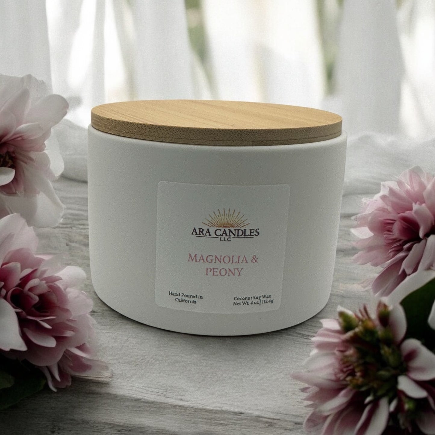 Magnolia and Peony scented candle by Ara Candles LLC, hand-poured in California with coconut soy wax, styled with soft pink floral decor for a calming, elegant atmosphere.