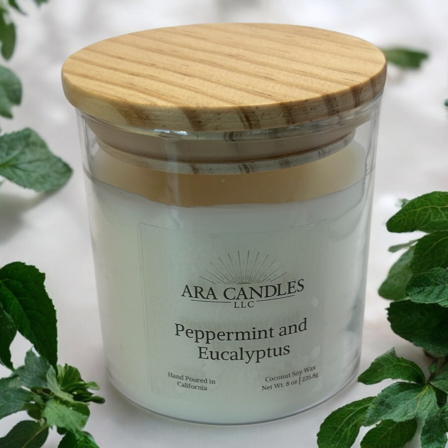 Peppermint Eucalyptus 8 oz flameless candle with a wooden lid, set against a peppermint background, offering a refreshing, invigorating fragrance in a flame-free form.