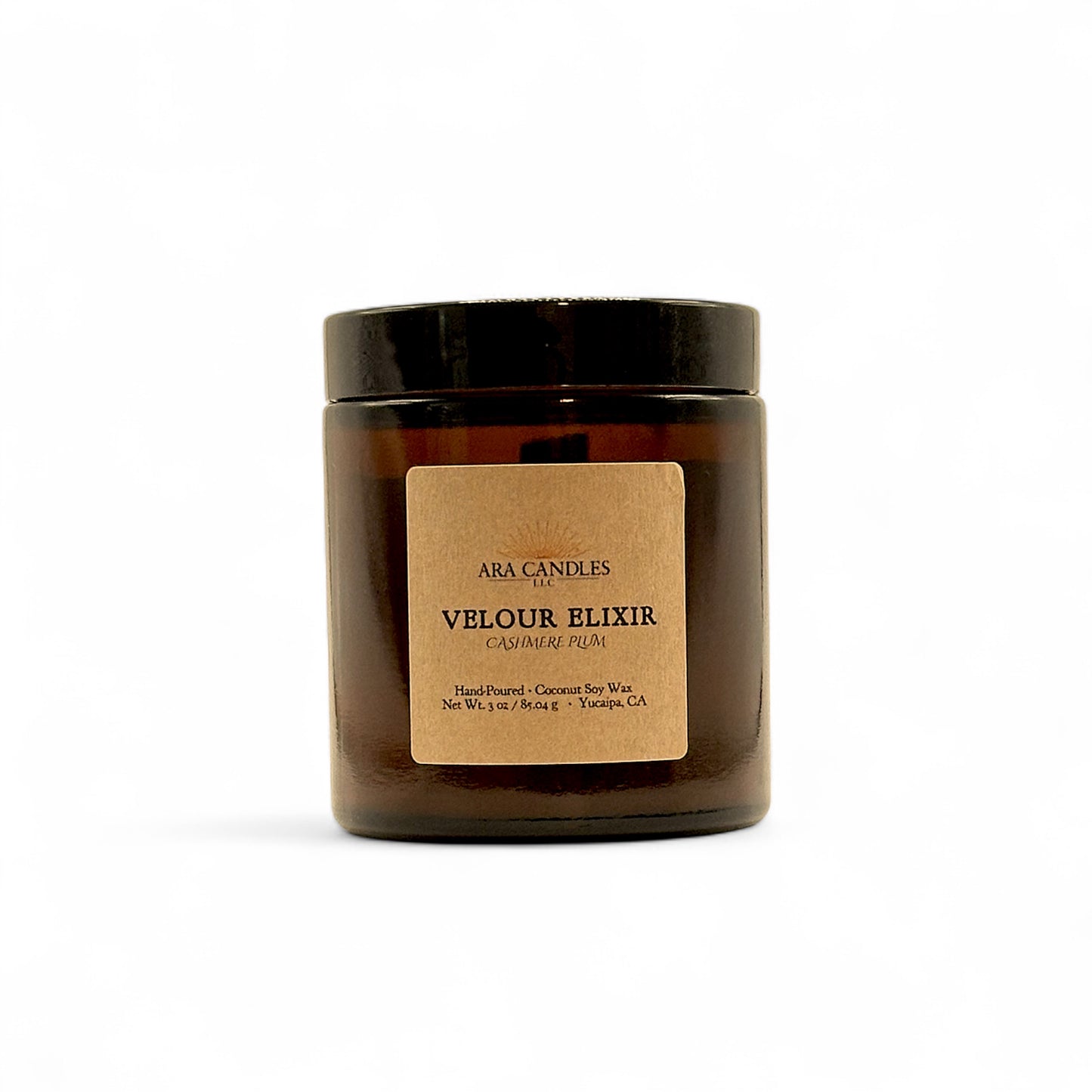 Ara Candles Velour Elixir candle in a clear jar with a brown label on a white background