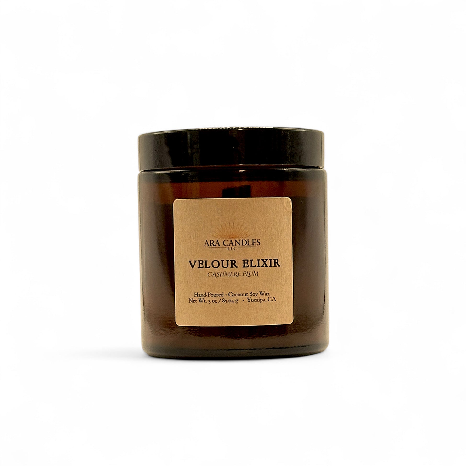 Ara Candles Velour Elixir candle in a clear jar with a brown label on a white background