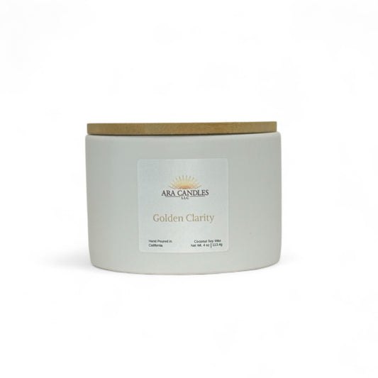 ARA Candles Golden Clarity ritual candle in a ceramic vessel with bamboo lid, crafted for focus and mindful intention.