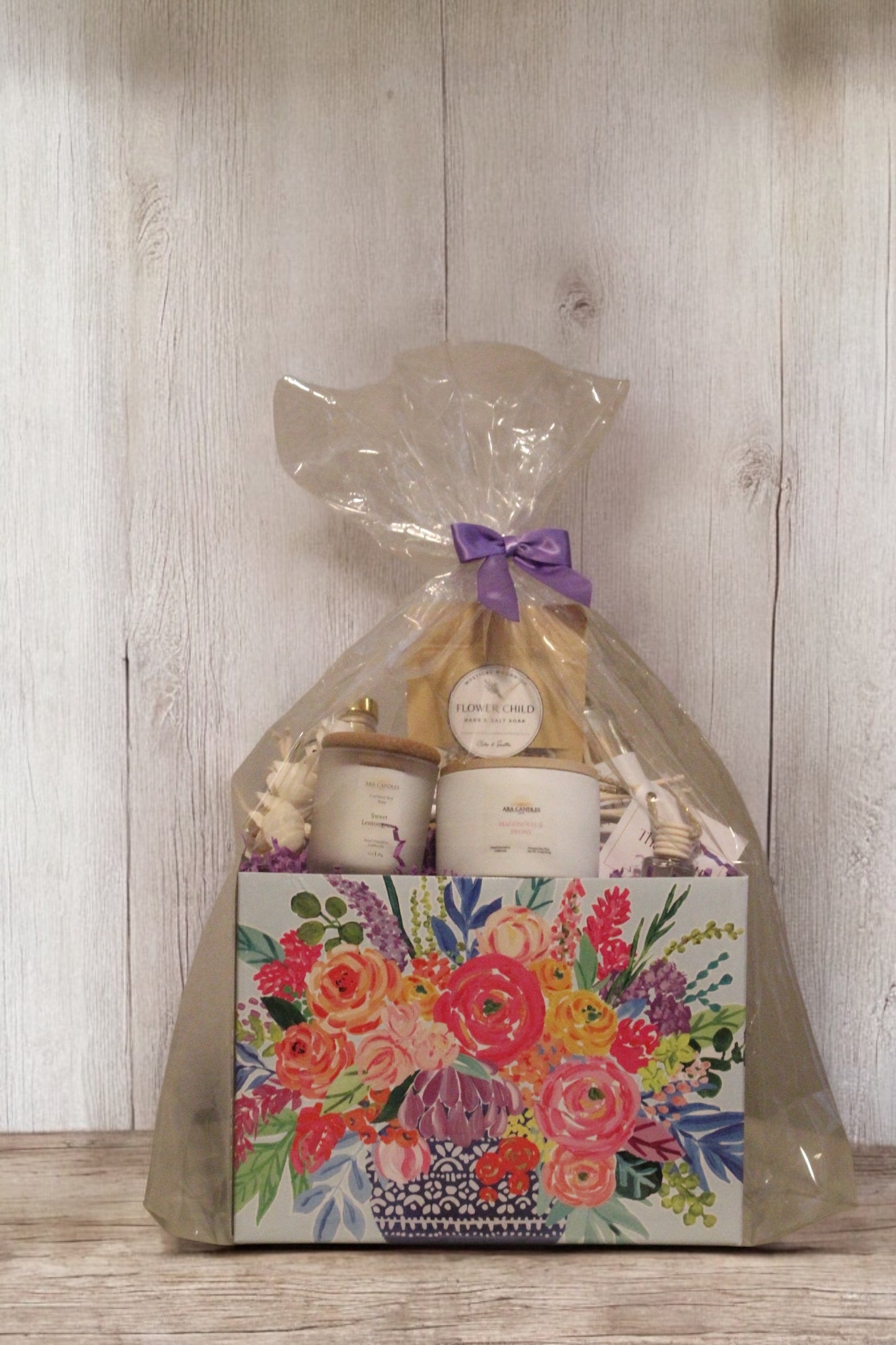 Mother’s Day gift box with floral packaging, includes Magnolia Peony and Sweet Lemon candles, car diffuser, reed diffuser, bath salt, and matches