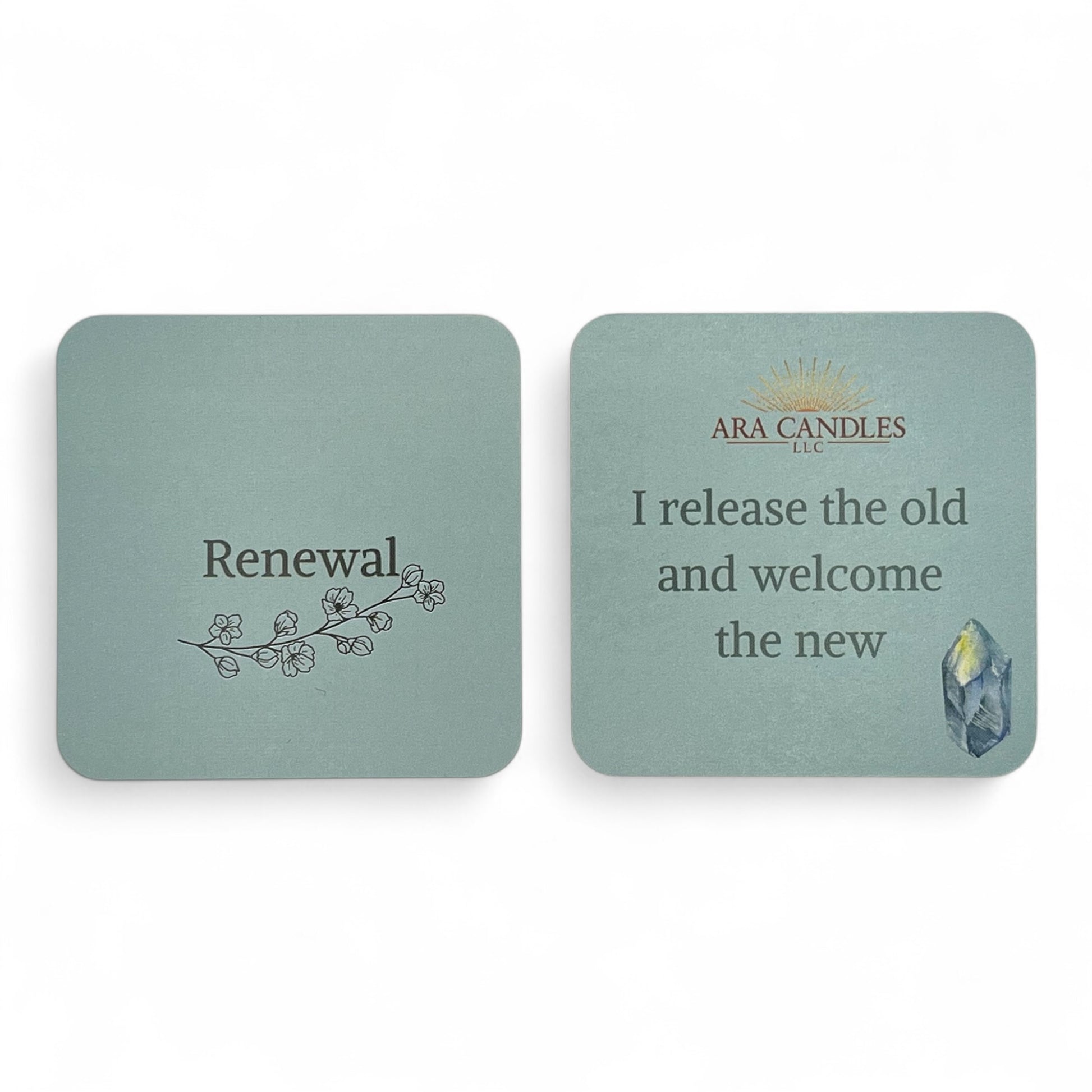RENEWAL affirmation card set from ARA Candles, with soft sage coloring, blossoming branch artwork, and the quote "I release the old and welcome the new" beside a healing crystal.