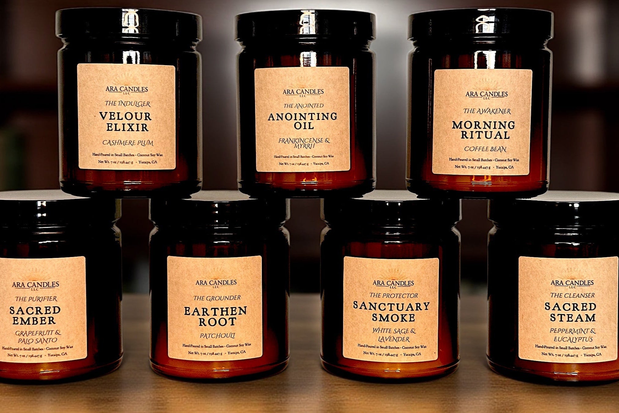 Ara Candles Apothecary Collection — seven ritual candles in amber glass, styled on a wooden surface