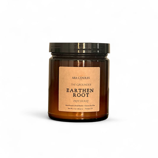 Ara Candles Apothecary Collection Earthen Root candle in amber glass, patchouli scent for grounding and stillness.