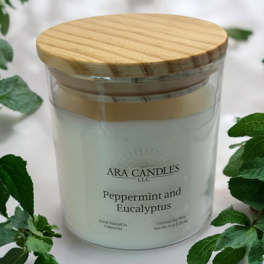Peppermint Eucalyptus 8 oz flameless candle with a wooden lid, set against a peppermint background, offering a refreshing, invigorating fragrance in a flame-free form.