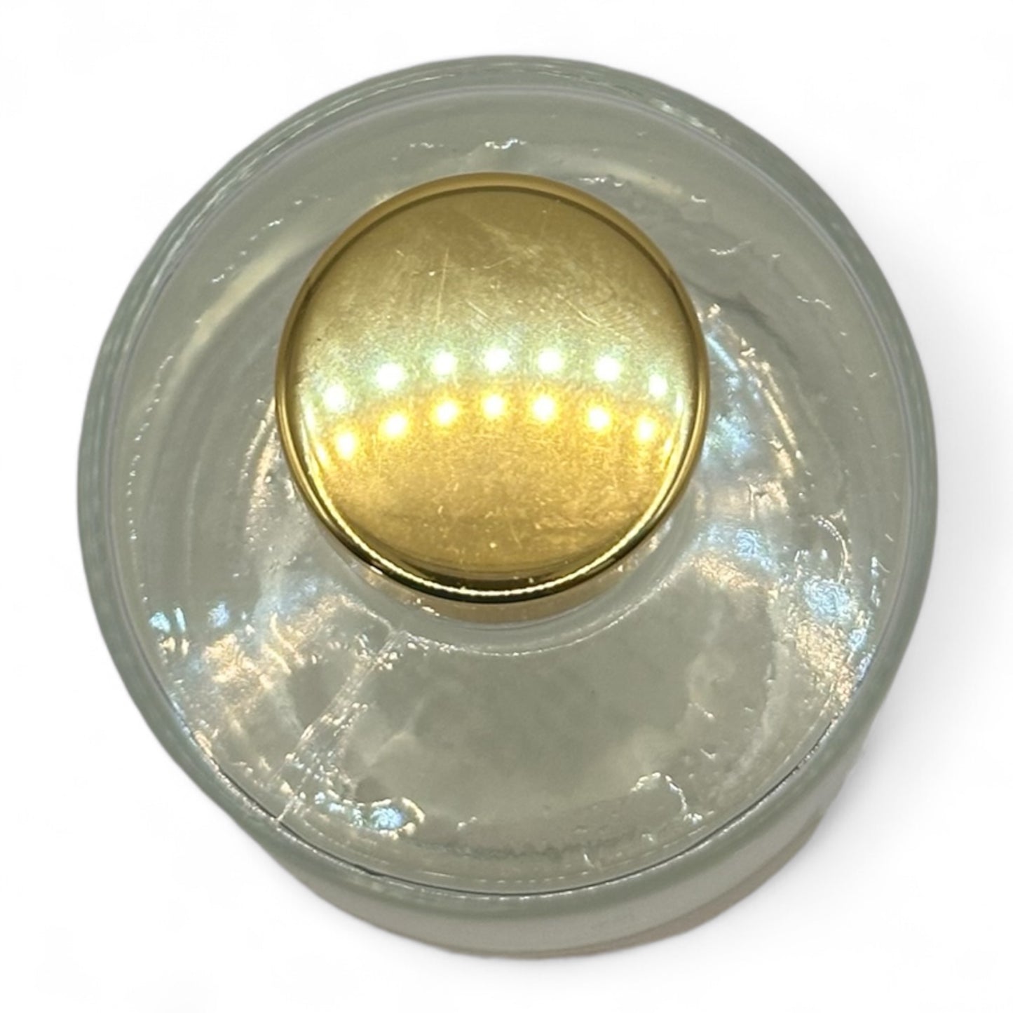 Top view of a reed diffuser with a gold cap, showcasing its elegant design and soothing fragrance for a calm, inviting atmosphere